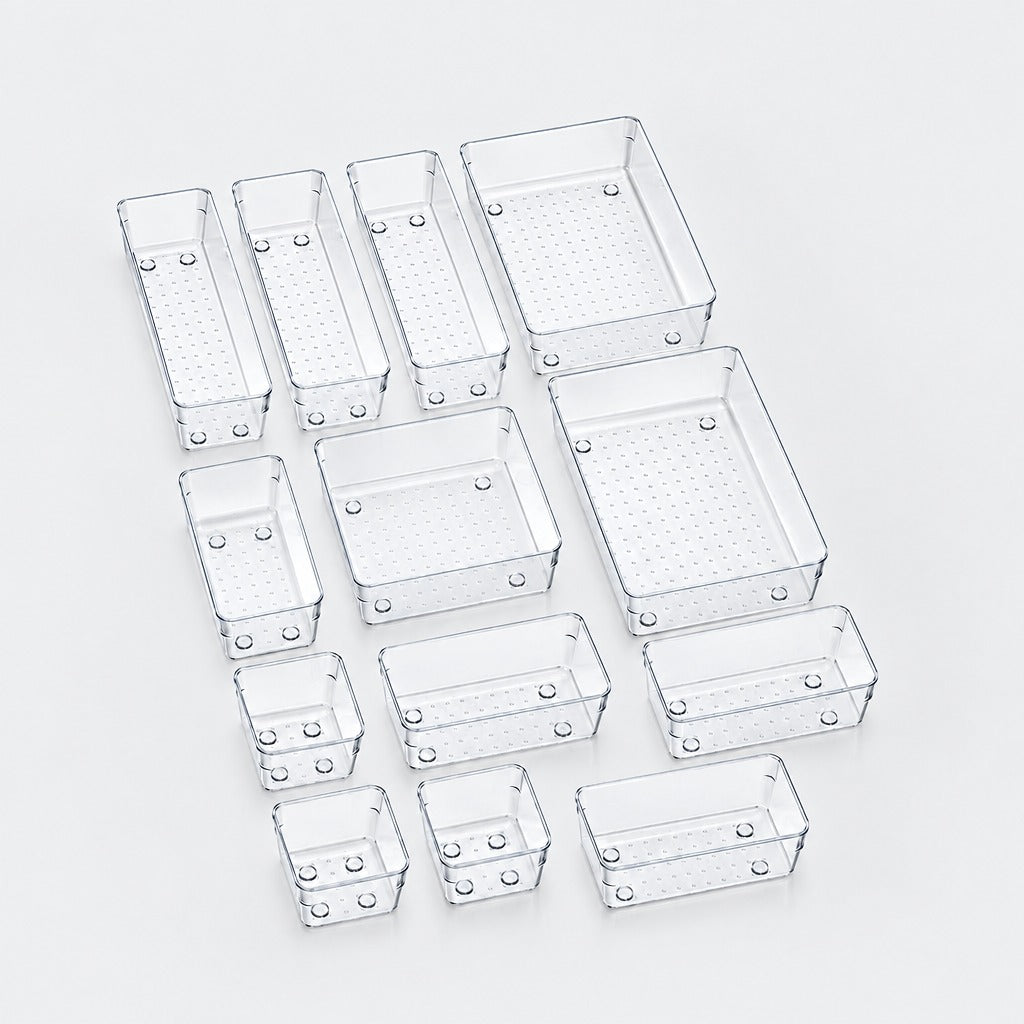 A set of clear plastic rectangular organizer bins in various sizes, arranged on a light gray background.