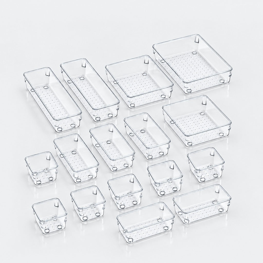 A set of clear plastic rectangular organizer bins in multiple sizes, arranged on a light gray reflective surface.