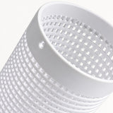 A close-up of a white plastic cylindrical basket or filter with a slotted grid pattern and a small hole in the rim, set against a clean white background.
