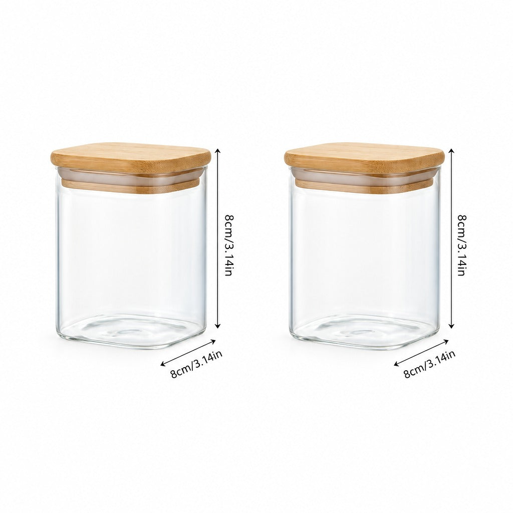 Two clear glass storage jars with light wood lids shown on a white background with dimension arrows and labels indicating 8cm height and 8cm width.