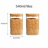 Two clear glass canisters with light wood lids, filled with beige beans, shown on a white background with dimension labels reading 12cm/4.7in height and 8cm/3.