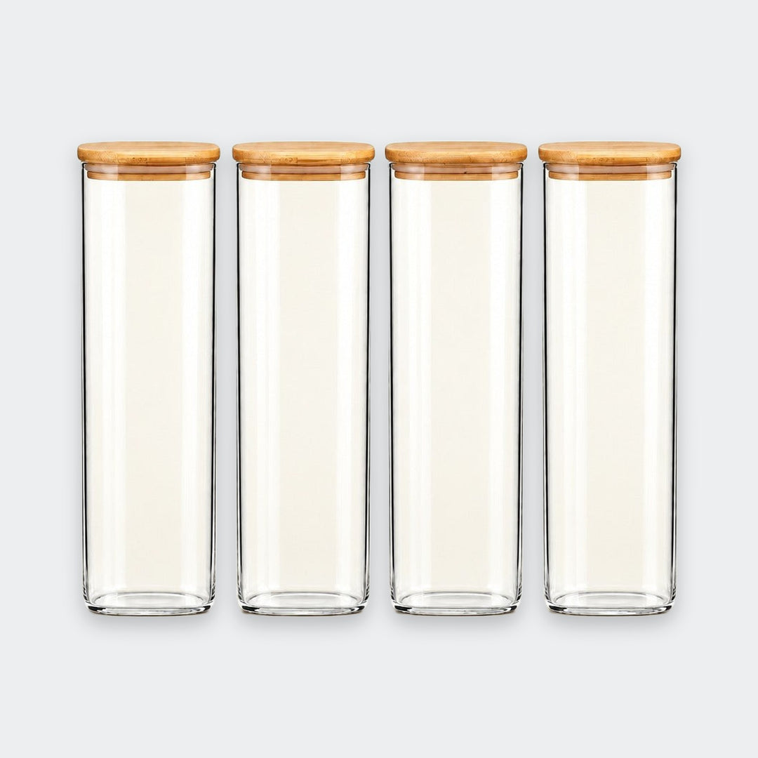 Four clear glass canisters with light brown bamboo lids, arranged in a row against a light gray background.
