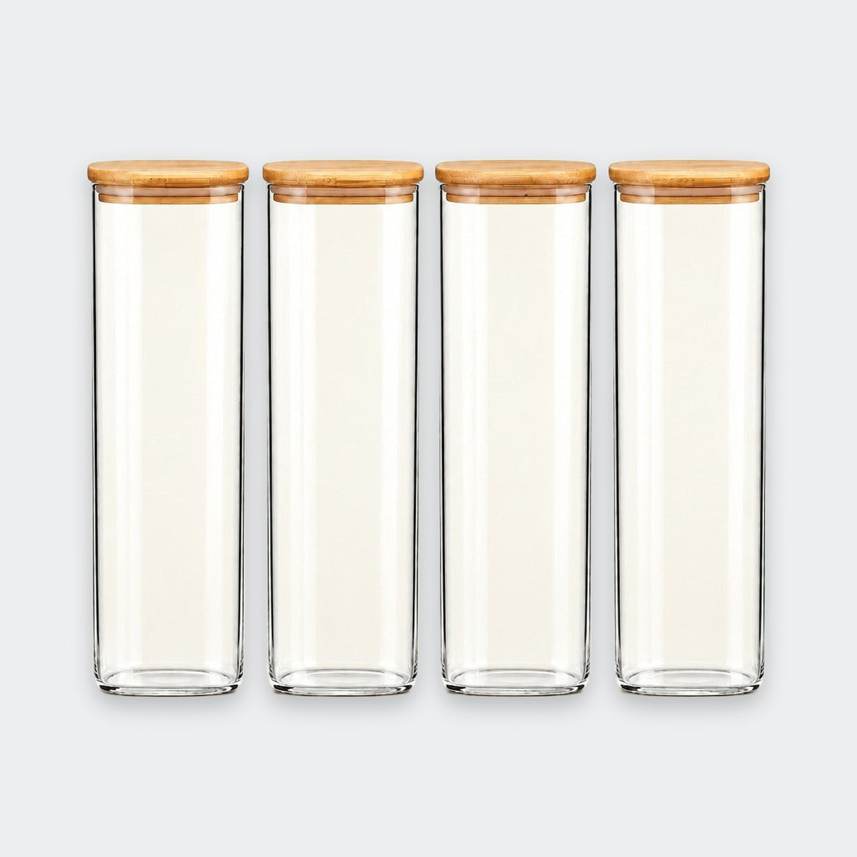 Four clear glass canisters with light brown bamboo lids, arranged in a row against a light gray background.