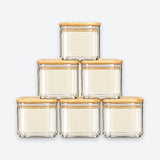 Six clear glass jars with square bases and light natural wood lids, arranged in a pyramid stack on a light gray background.