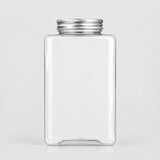 A clear rectangular glass jar with rounded corners and a silver metal screw-on lid, shown on a light gray background.