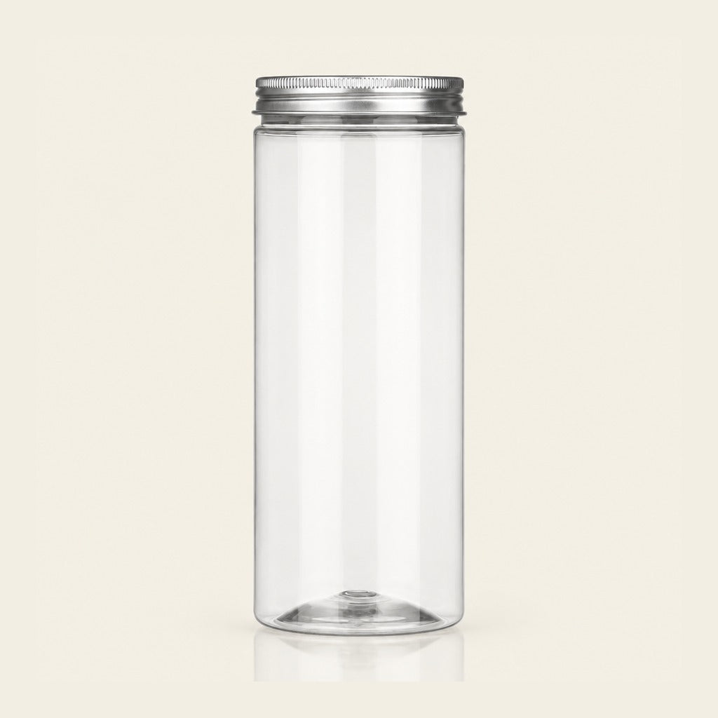 A tall, clear cylindrical plastic jar with a silver metal screw-on lid, shown against a solid light beige background.