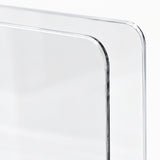 Close-up of a transparent acrylic or glass panel with rounded corners and a smooth reflective surface on a white background.