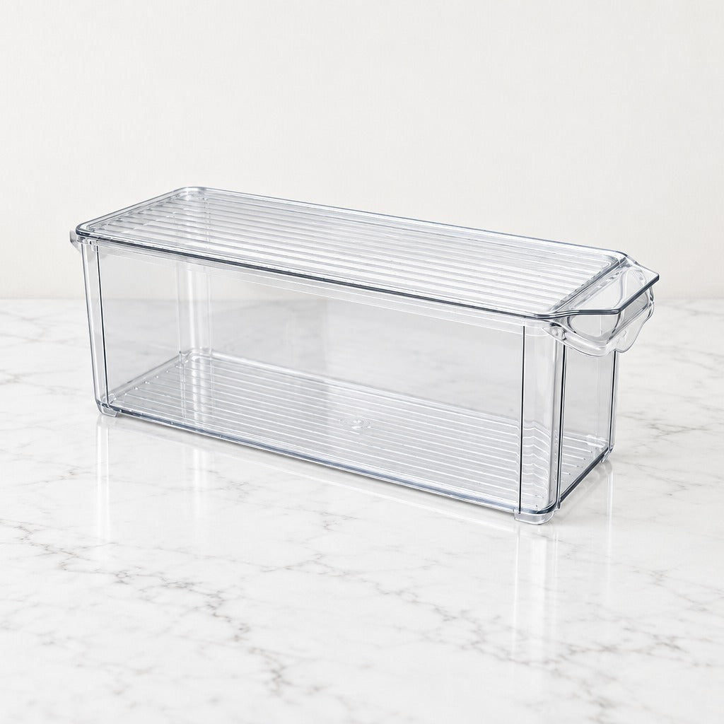 A clear plastic refrigerator storage bin with a ribbed lid and side handle, shown on a white marble surface against a white background.