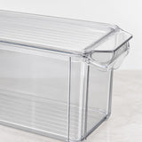 Clear plastic food storage container with a slotted lid and integrated handle, shown on a light marble surface against a white background.