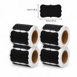 Four rolls of black chalkboard-style labels with white backing, shown on a white background with a small size callout indicating 3cm by 5cm.