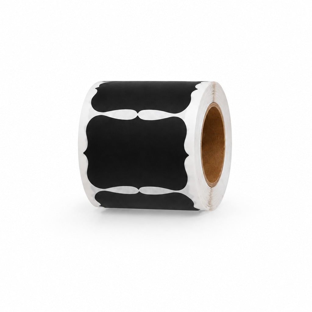 A roll of black and white decorative labels with a scalloped border design, mounted on a brown cardboard core, set against a plain white background.