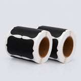 Two rolls of cow-print labels with black and white spots on a light gray background.