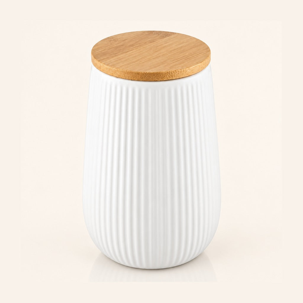 A white ribbed ceramic jar with a natural bamboo wood lid, shown on a light cream background.