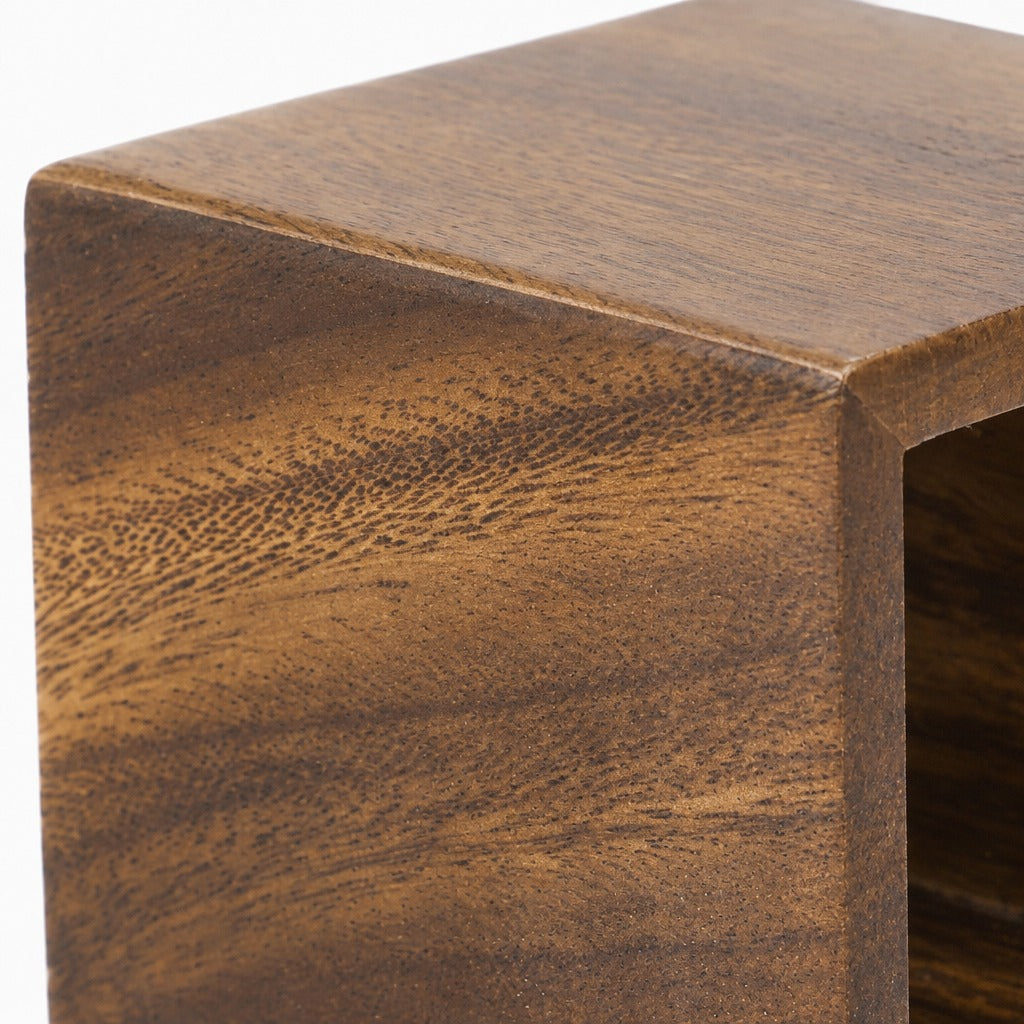 Close-up of a wooden furniture corner showing a rich medium-to-dark brown wood grain texture on a white background.