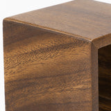 Close-up of a wooden furniture corner showing a rich medium-to-dark brown wood grain texture on a white background.
