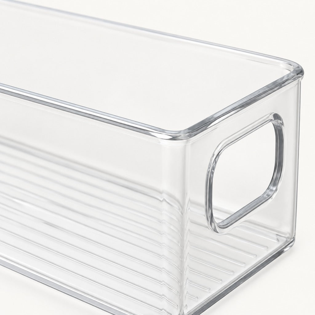 Clear plastic storage bin with a rounded handle on a white background.