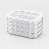 A stack of four clear plastic dehydrator trays with a white plastic lid, shown on a clean white background.