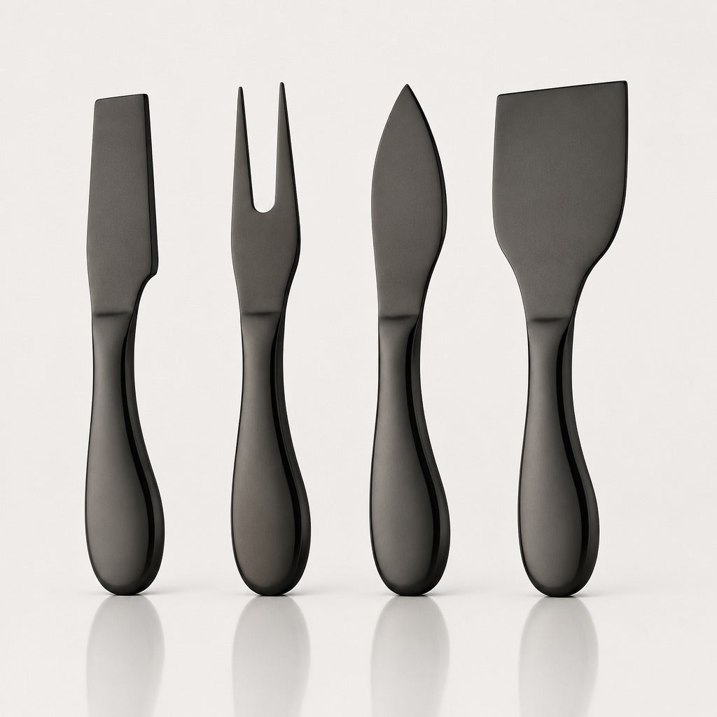 Four matte black cheese knives with different blade shapes, arranged in a row on a light gray reflective surface.