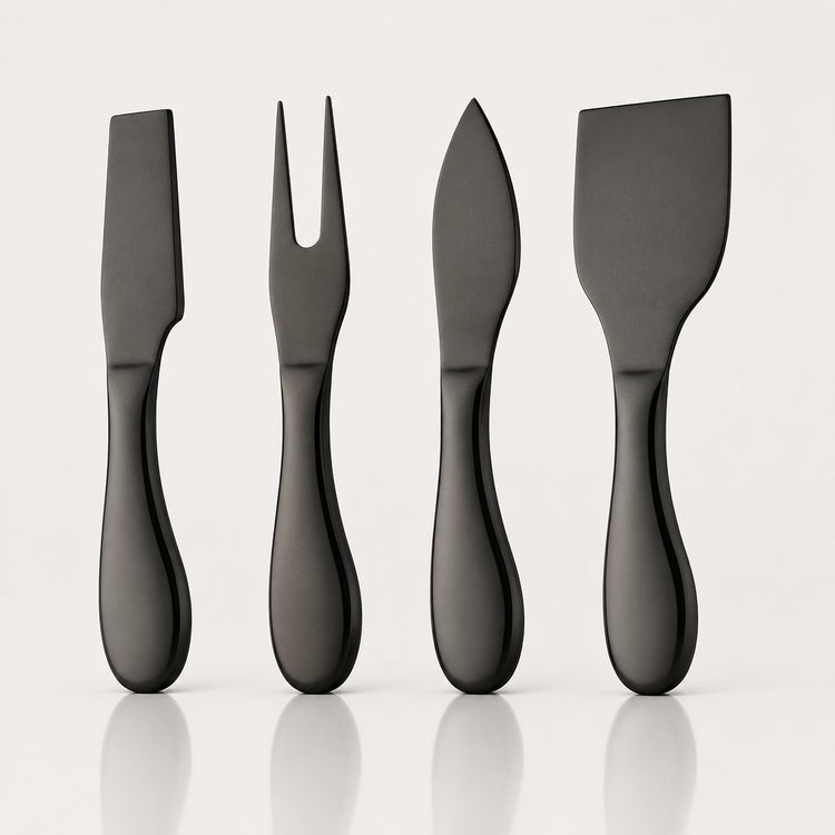 Four matte black cheese knives with different blade shapes, arranged in a row on a light gray reflective surface.
