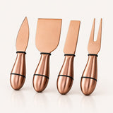 Four metallic copper-colored cheese and fruit utensils with black bands near the handles, arranged upright on a clean white background.