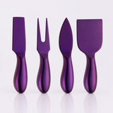 Four metallic purple cheese knives and spreaders with matching purple handles, arranged upright on a clean white background.