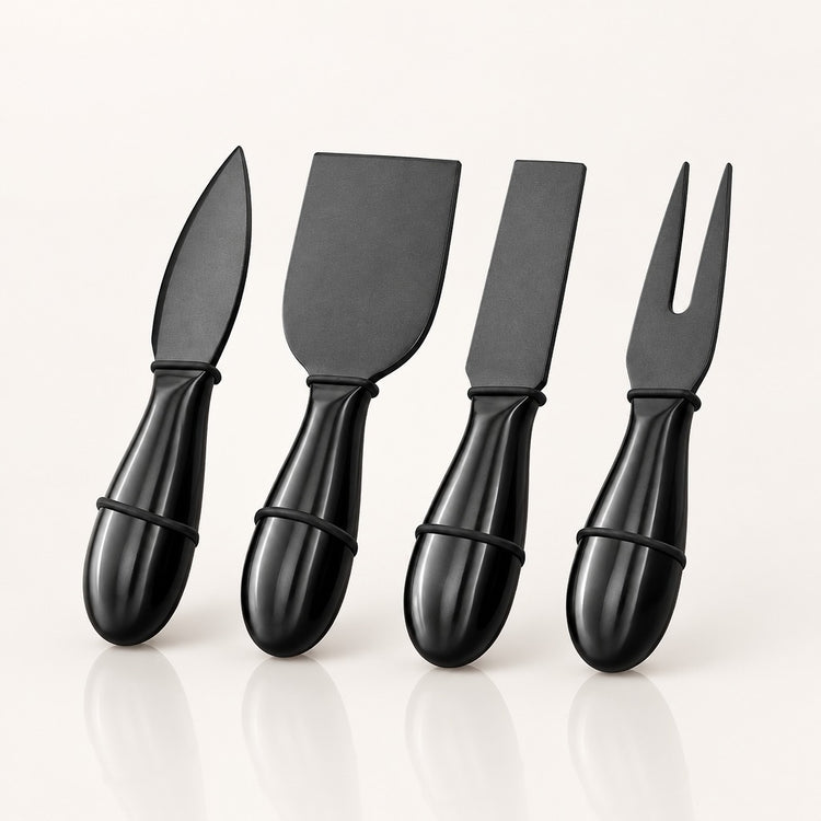 Four black cheese knives with glossy handles, including a knife, a spatula, a straight knife, and a fork, arranged in a row on a light off-white background.
