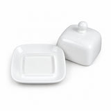 A white ceramic butter dish with a square lid featuring rounded corners and a small spherical knob on top, shown next to its matching square base plate on a clean white background.