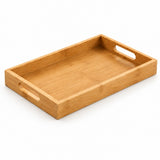 A rectangular bamboo serving tray with integrated cutout handles on two short ends, shown at an angle on a white background.