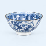 A blue and white porcelain bowl featuring hand-painted dragon and cloud motifs, with a thin dark rim and a small pedestal base, photographed against a light blue background.