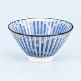 A blue and white striped ceramic bowl with a black rim, shown on a light blue background.