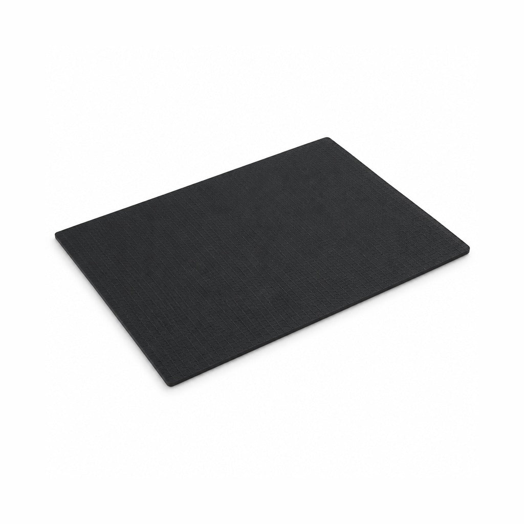 A black rectangular cutting board with a textured surface, shown at an angle on a plain white background.