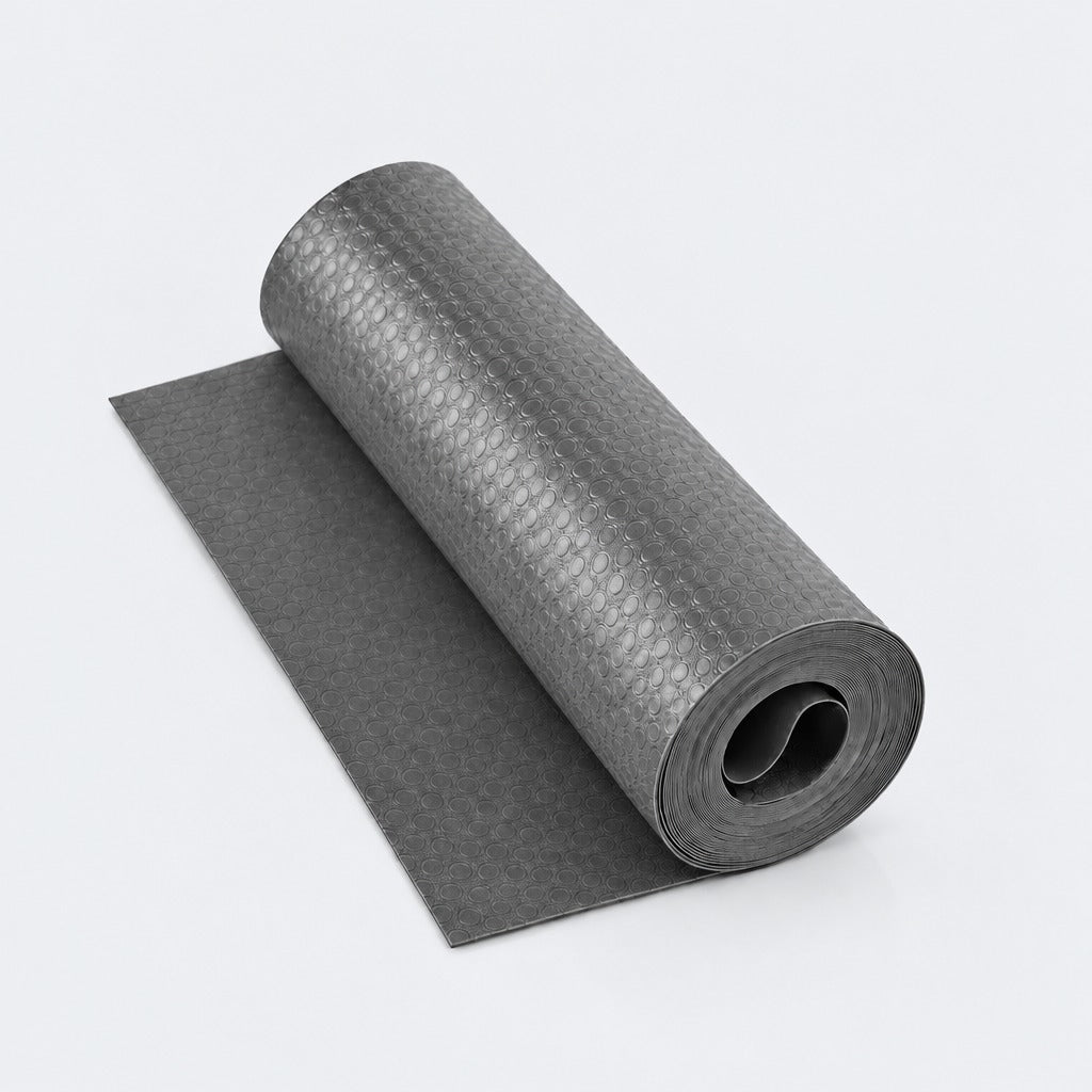 A dark gray yoga mat shown partially unrolled, revealing a textured honeycomb pattern on the rolled section and a smooth matte surface on the flat section, set against a clean white background.