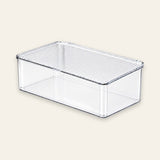 A clear plastic storage box with a slotted lid, shown at an angle on a light beige background.