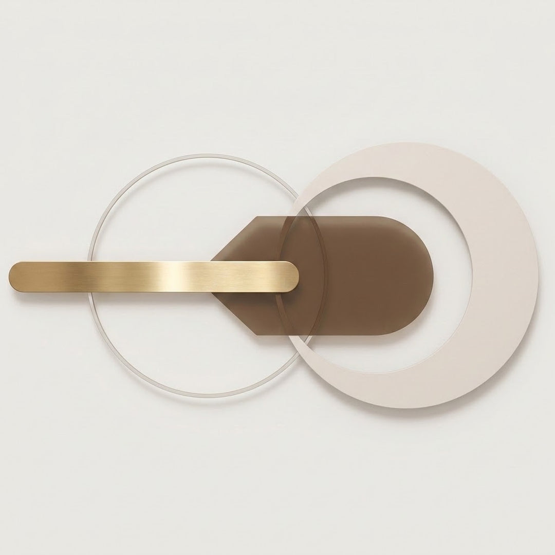 A modern wall-mounted light fixture with overlapping circular and curved geometric elements in beige, brown, and brushed gold metal, shown against a clean off-white background.