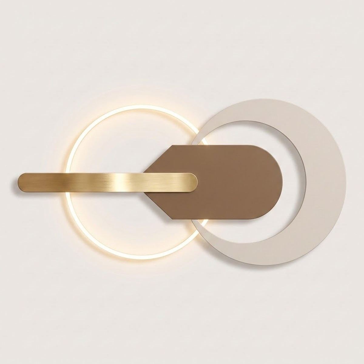 Modern wall sconce with a glowing circular ring, a horizontal brushed gold bar, and overlapping matte white and brown geometric shapes on a light neutral background.