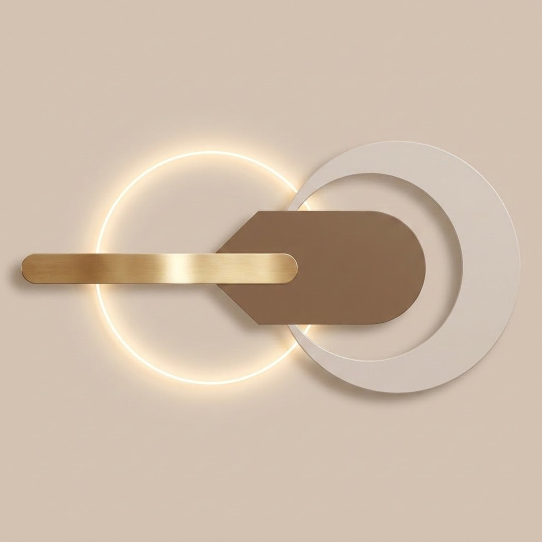Wall light with overlapping white and illuminated circular forms, a taupe central plate, and a gold-tone horizontal bar against a beige background.