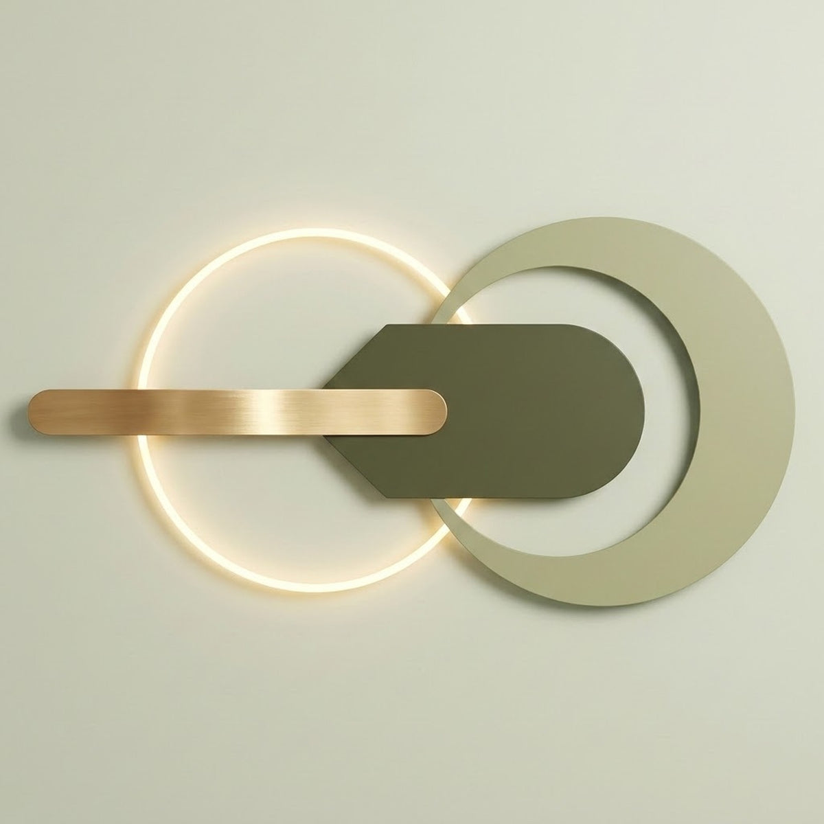 Modern wall-mounted light fixture with a glowing circular ring, a large matte off-white crescent shape, a dark olive green central shield, and a horizontal brushed brass bar against a light neutral wall.