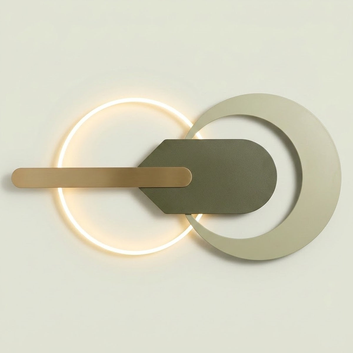 Modern wall sconce with a glowing circular ring, a horizontal brushed brass bar, and a dark gray geometric shield overlay on a light beige background.
