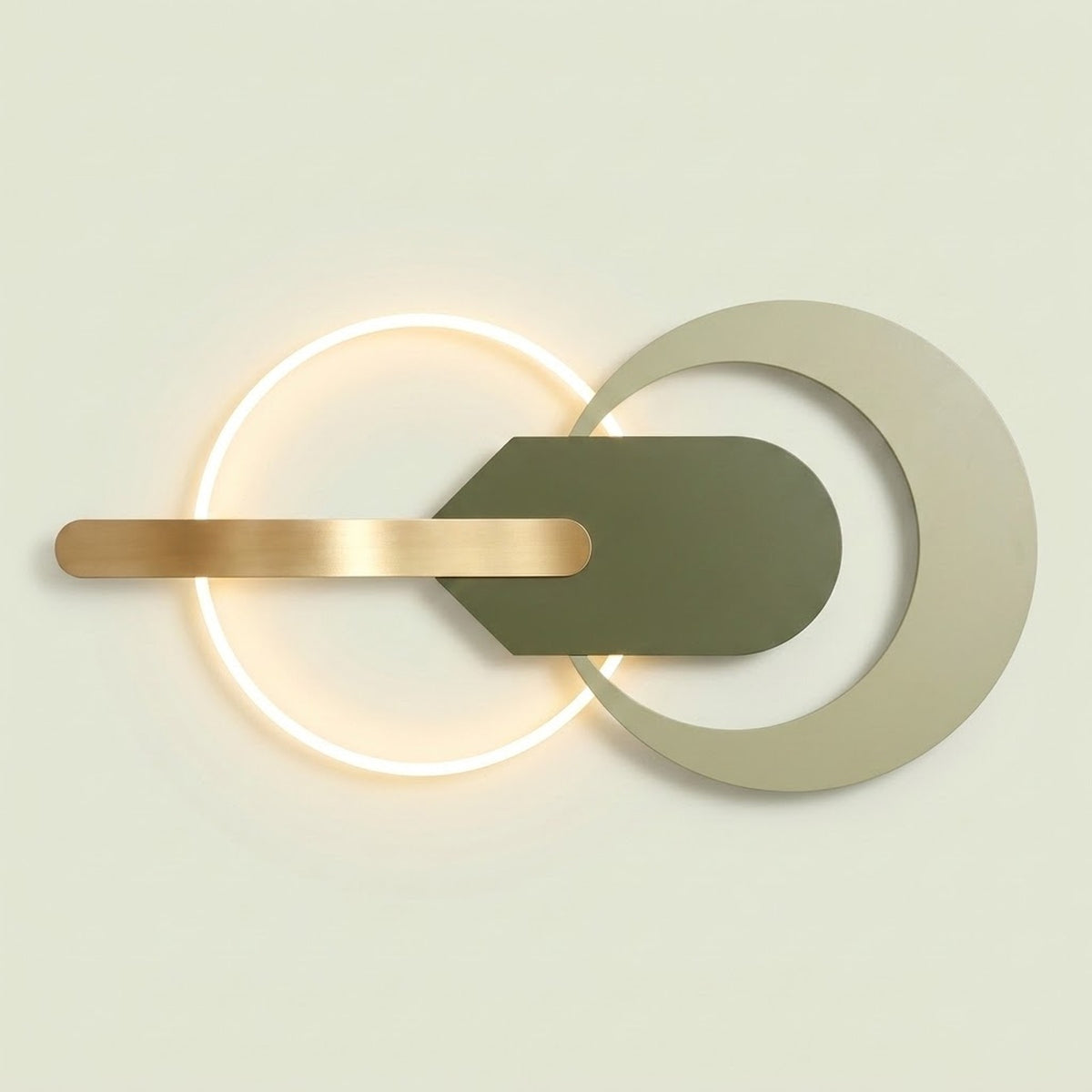 Modern wall sconce with a glowing circular ring, a horizontal brushed gold bar, and a central dark olive green shield shape layered over a large pale beige ring on a light warm background.