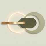 Modern wall-mounted light fixture with a glowing circular ring, a matte olive green geometric central element, and a brushed brass horizontal bar on a light beige background.