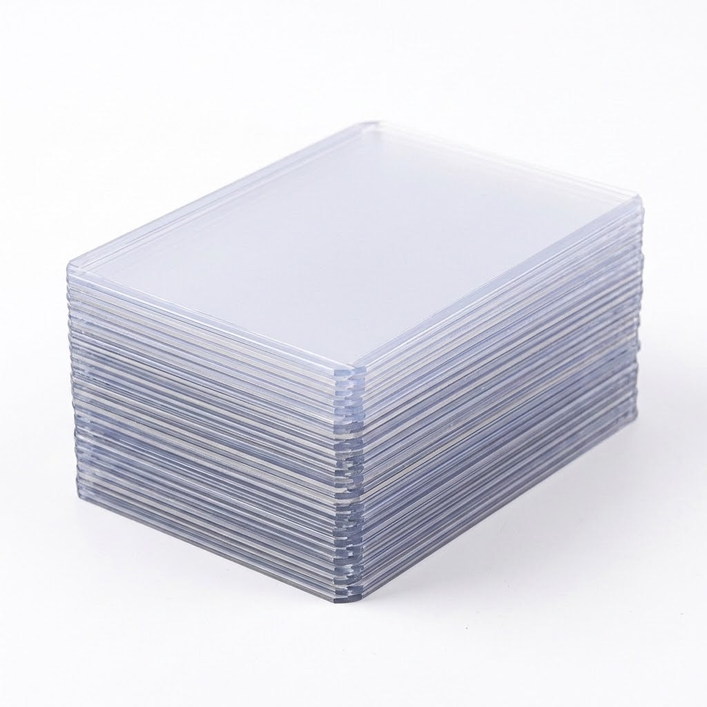 A stack of clear plastic card sleeves or protective cases, photographed on a clean white background.