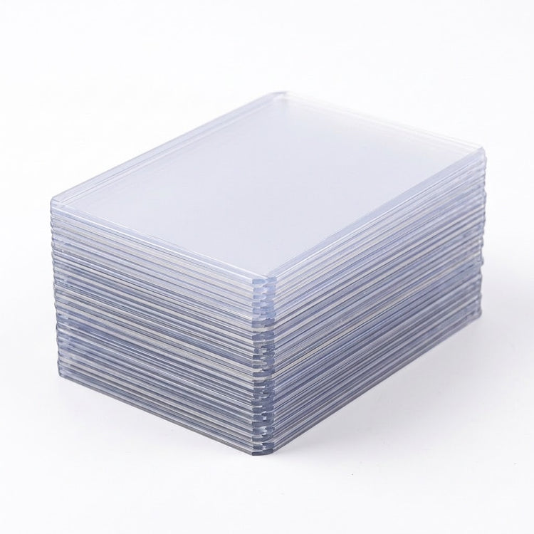 A stack of clear plastic card sleeves or protective cases, photographed on a clean white background.