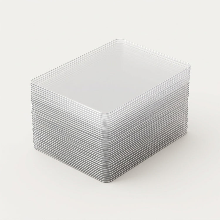 Clear hard card sleeves are stacked neatly with rounded corners and layered edges visible against a light background.