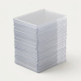 A stack of clear plastic square card sleeves or protective cases, photographed on a clean off-white background.