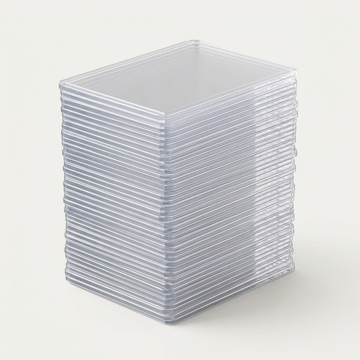 A stack of clear plastic square card sleeves or protective cases, photographed on a clean off-white background.