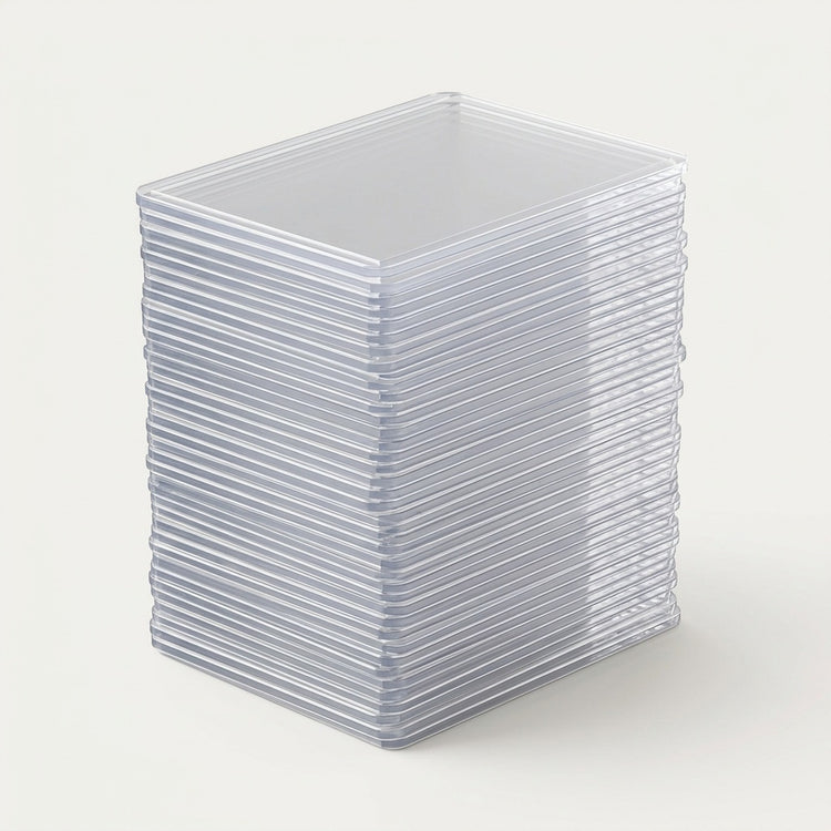 A stack of clear plastic square card sleeves or protective cases, photographed on a clean off-white background.