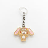 A Sanrio character keychain featuring a translucent, pale peach-colored bunny charm with pink inner ears, a small pink bow, and a white belly, attached to a silver chain and a clear plastic key ring on a white background.