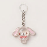A translucent acrylic keychain charm shaped like a cute bunny character with long floppy ears, a silver metal chain, and a clear plastic key ring, shown on a plain light background.
