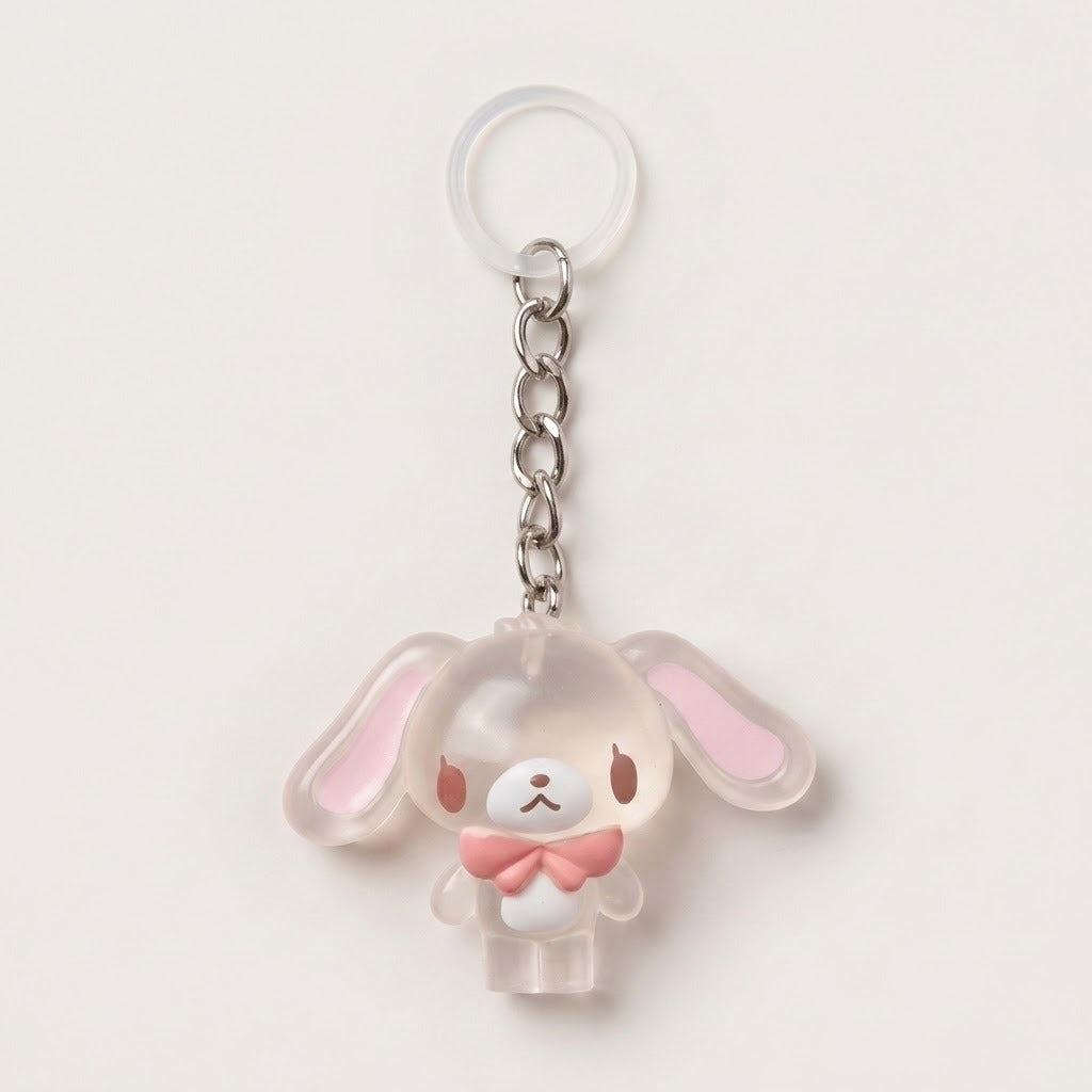 A translucent acrylic keychain charm shaped like a cute bunny character with long floppy ears, a silver metal chain, and a clear plastic key ring, shown on a plain light background.