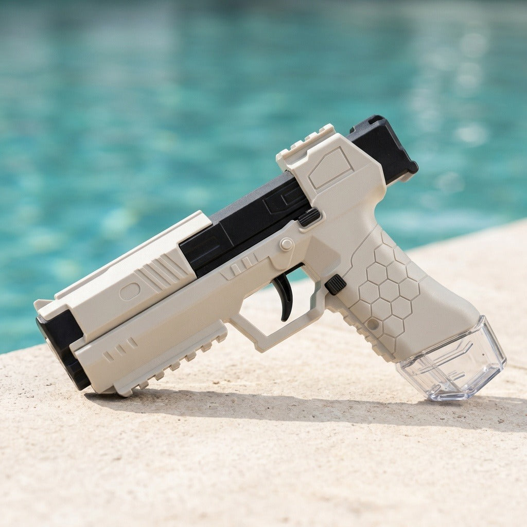 White and black water squirt gun with a hexagonal grip and clear reservoir rests diagonally on a sunlit poolside ledge.